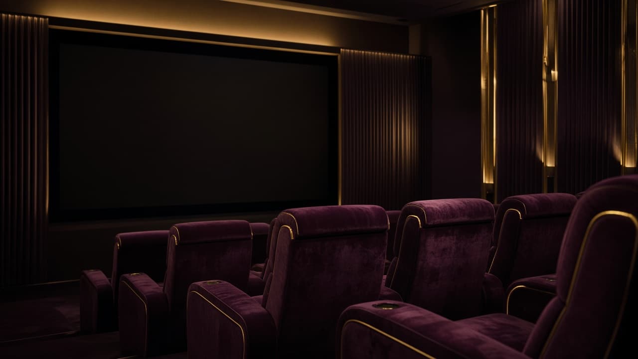 A cinema interior in gold and plum light